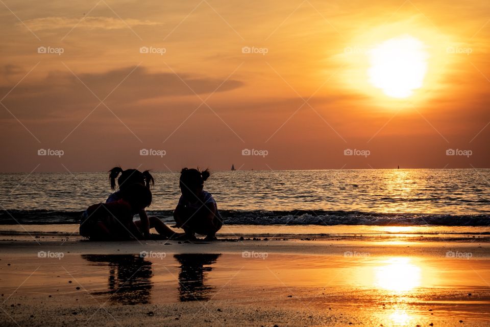 Three sisters play on the Thailand beautiful beach