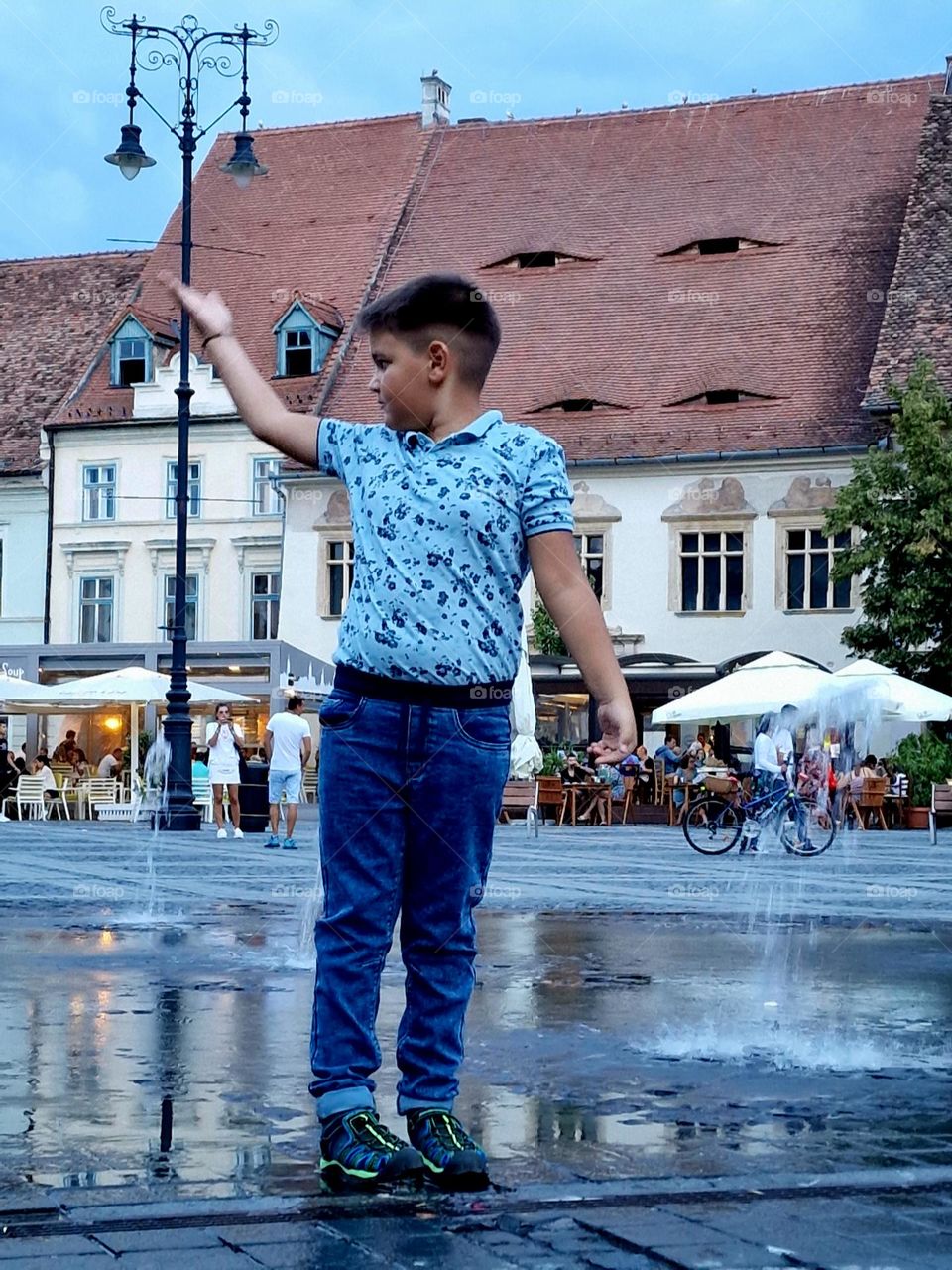 child presenting the artesian fountain that comes out of the mant