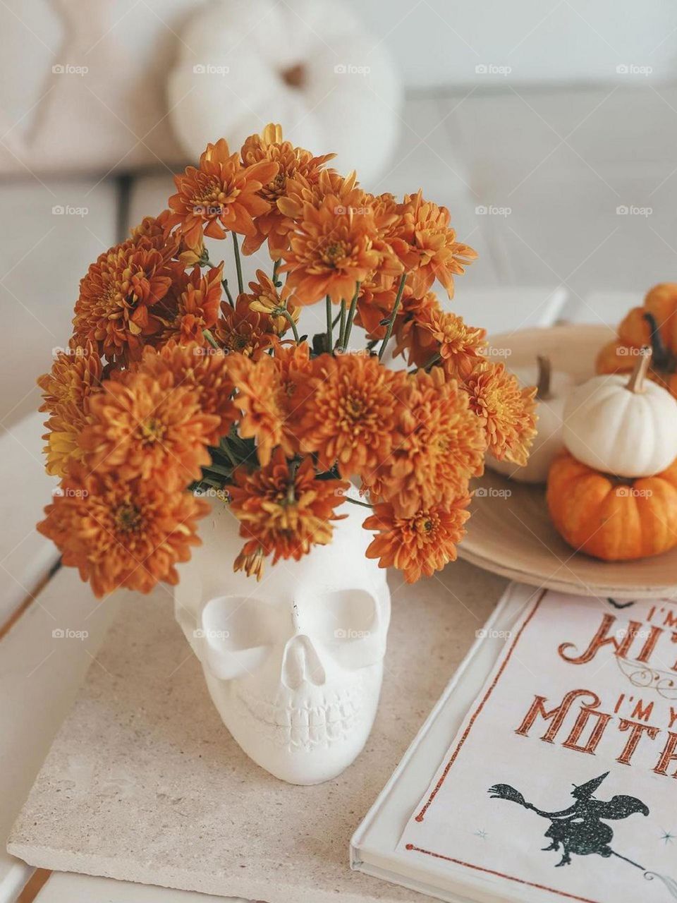 Skeletons, pumpkins and witch tales and a bouquet of orange flowers make a beautiful Halloween