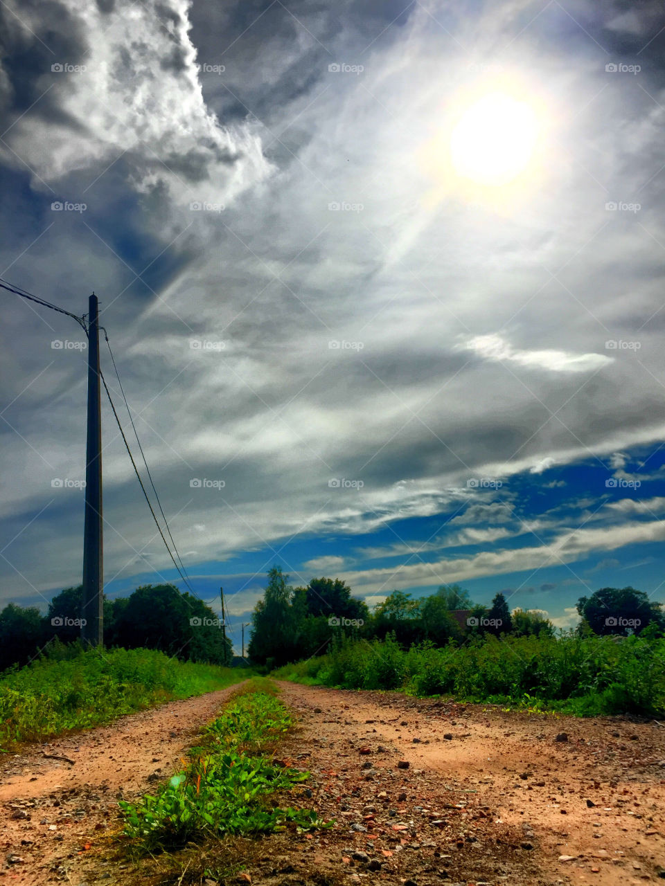 Dust road under a grey sky