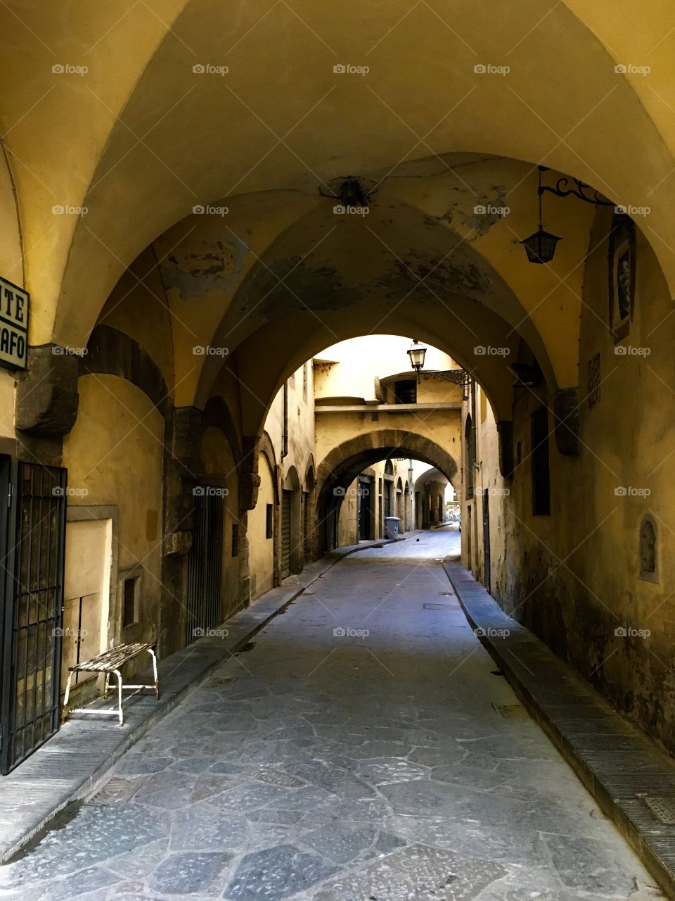 A beautiful old arched alleyway snaking through the tiny side streets of Venice. 