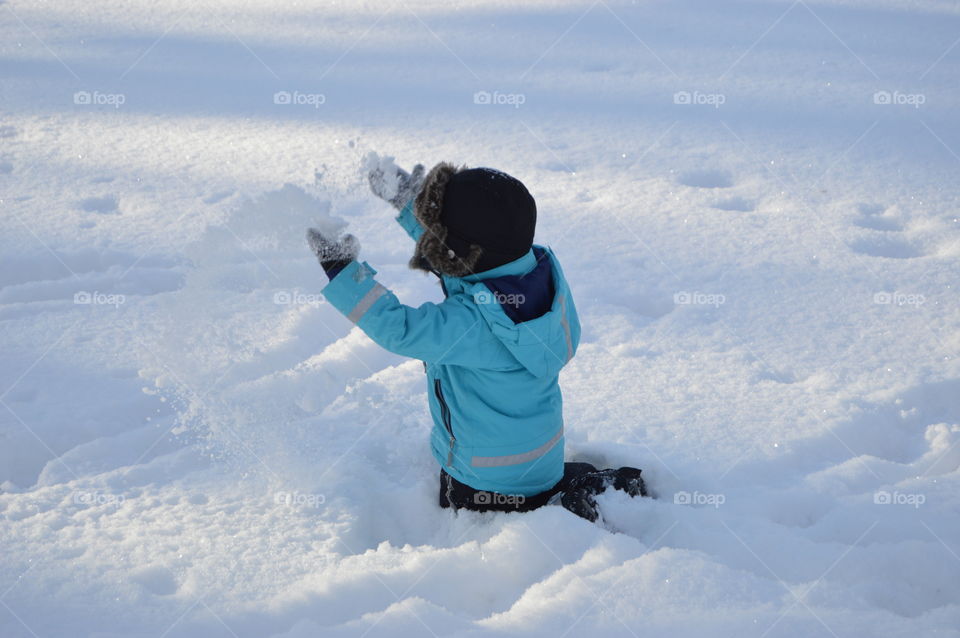 Boy playing in snow