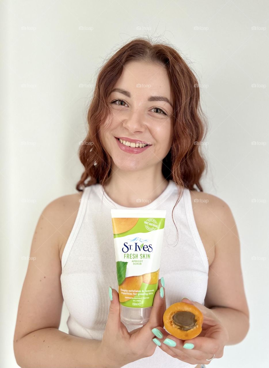 St. Ives fresh skin apricot scrub. Natural cosmetic for everyone. Photo without retouching. Natural beauty. Beautiful smile, beautiful young woman. 