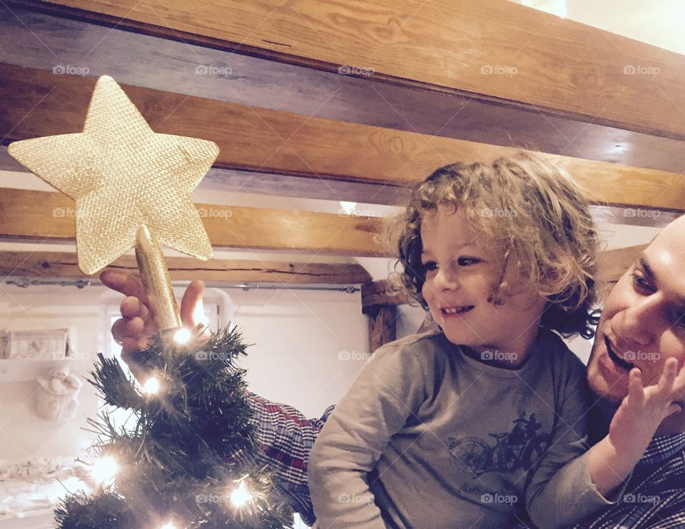 Father and daughter looking at christmas tree