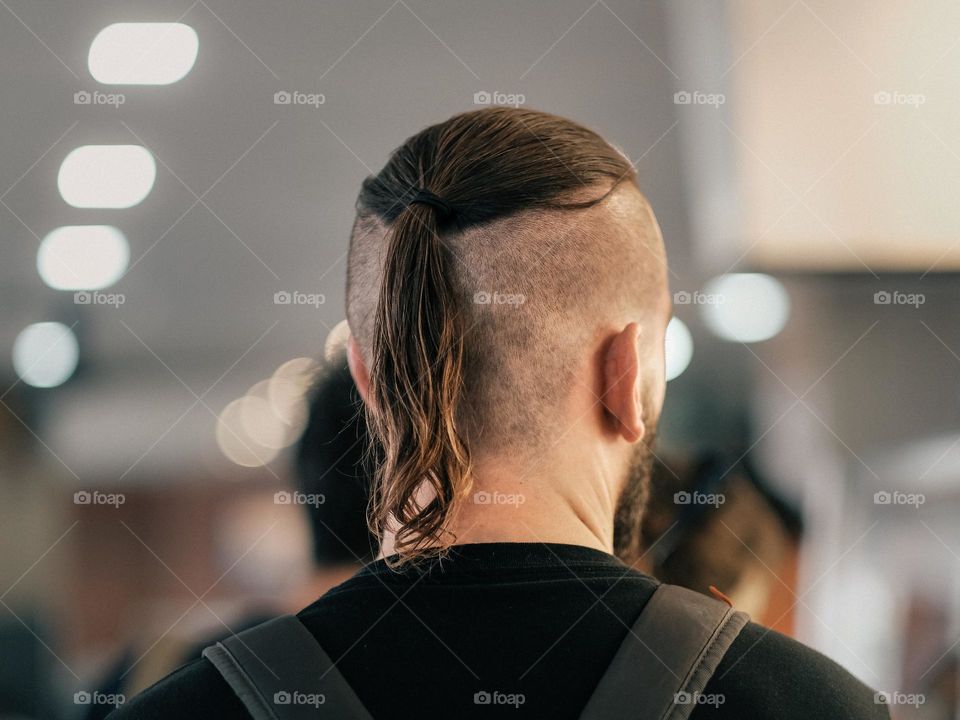 A man with a new pony tail hair style