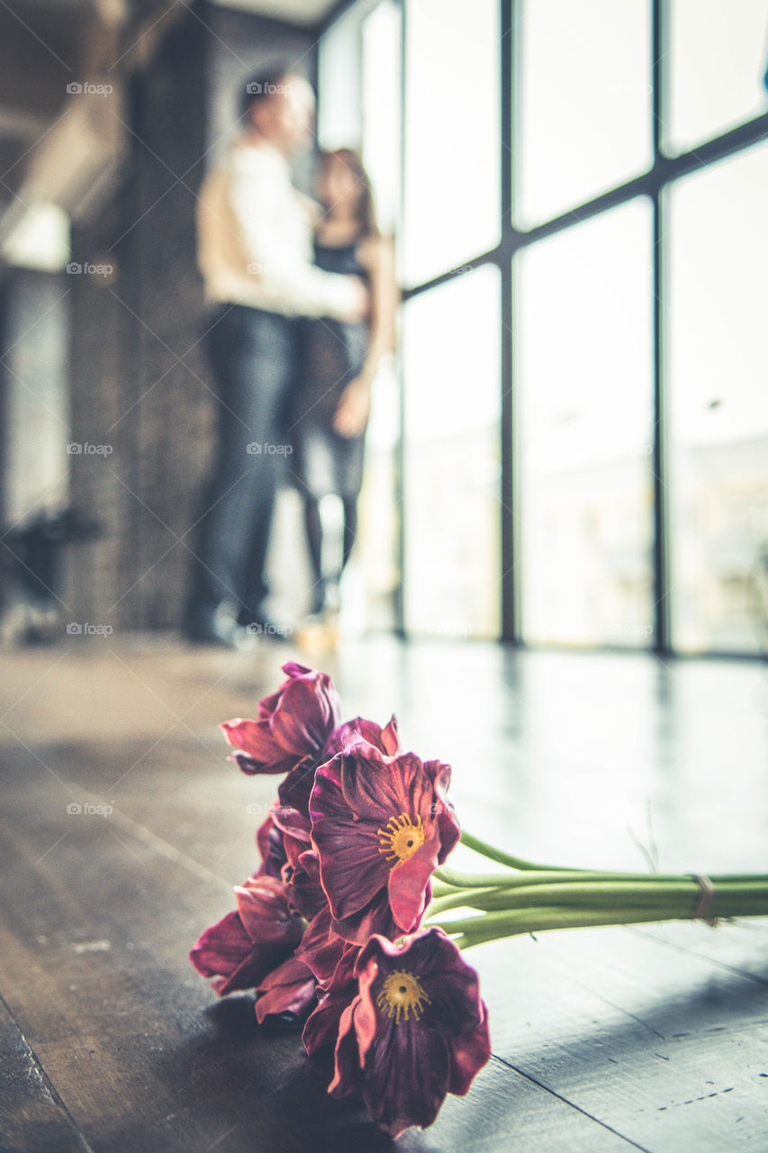 Young couple near a big window