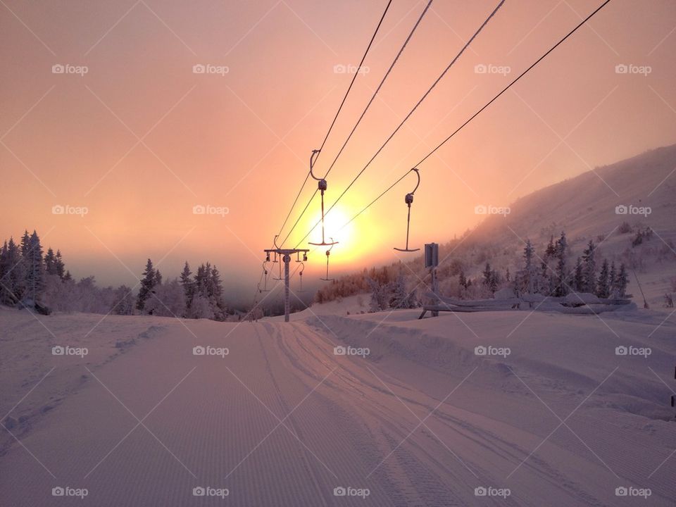 A chairlift in snowy mountains
