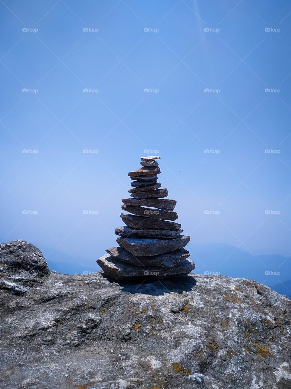 A tower of stone built from small pieces of stones on top of a mountain