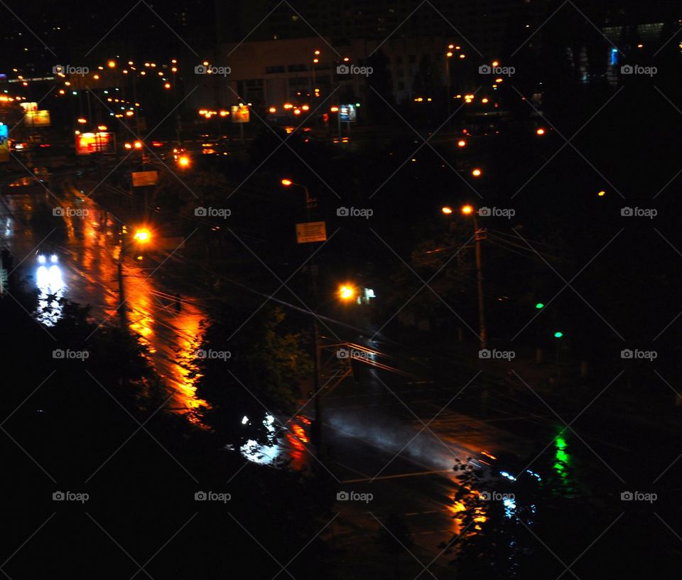 Nightly streets of Kiev, wet road, road after a rain, track from machine headlights