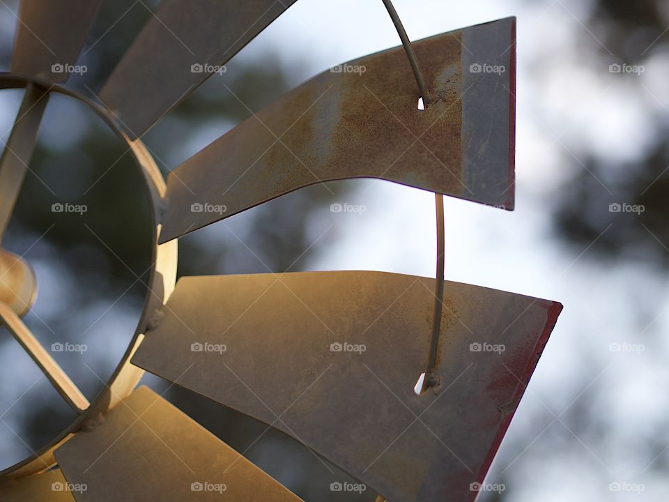 Detailed blades on a decorative retro windmill for landscaping on a nice evening. 