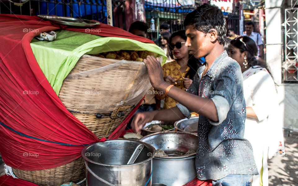Kolkata, West Bengal, India, January 2019: A Puchka Wala selling Puchka also called Pani Puri or Golgappa in the street of kolkata. A famous street food of kolkata.