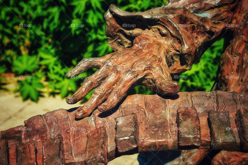 Close-up of a sculpture in a park of a man playing piano.