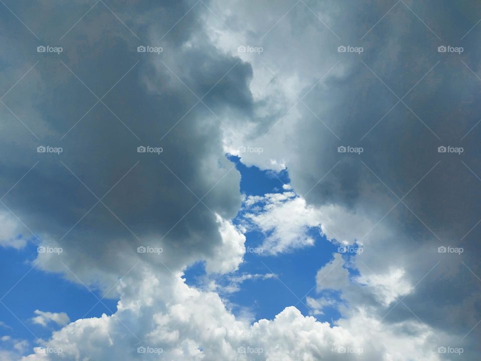 Bright clouds and dark clouds in the blue sky