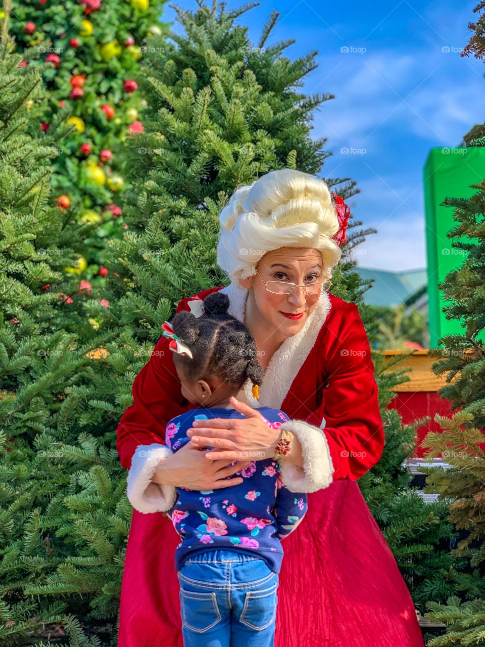 Little girl meeting Mrs. Clause for the first time