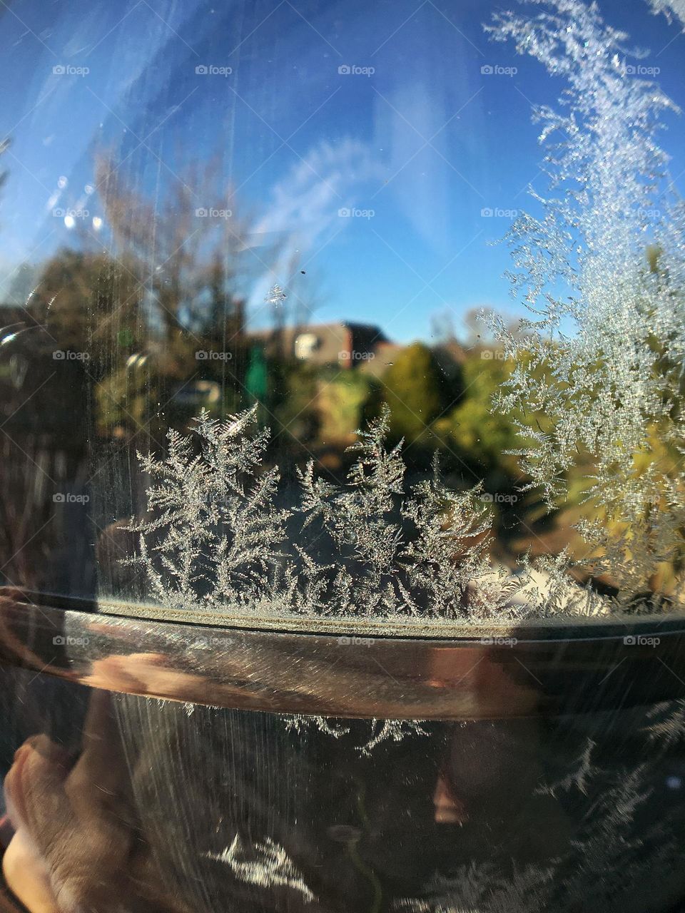 Little icy snowflake on a glass door 