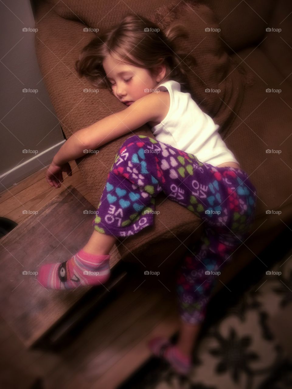 High angle view of girl sitting on sofa