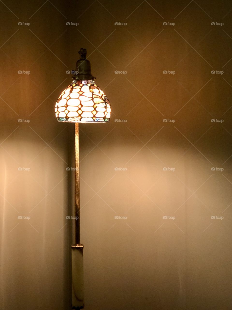 Home interior corner with floor lamp and Tiffany style shade 