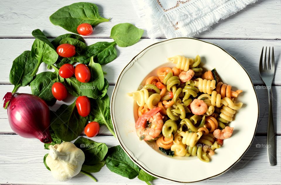 Trottole tricolore with shrimp and basil leaves