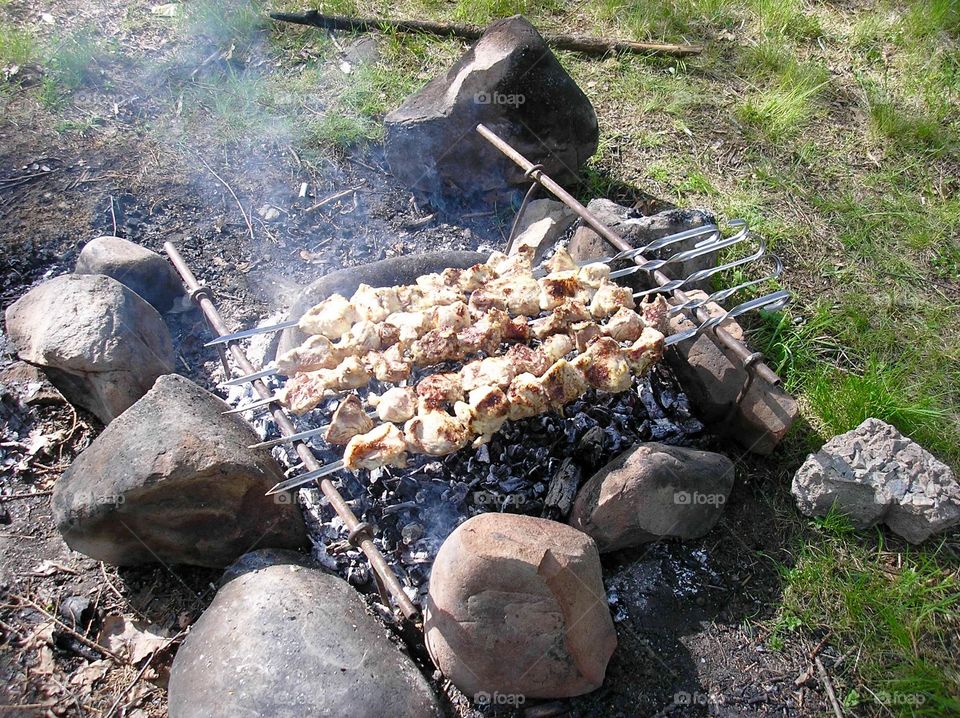 Picnic  cooking fried meat in the nature