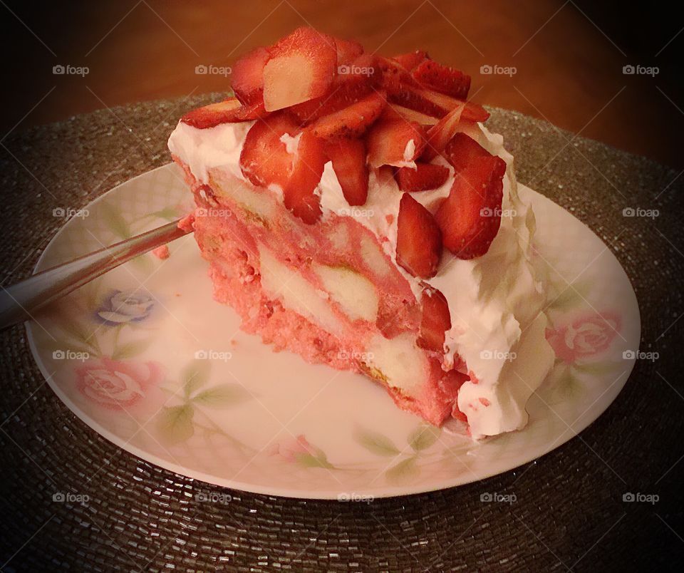 Beautiful homemade strawberry layered cake with lots of whipped cream.