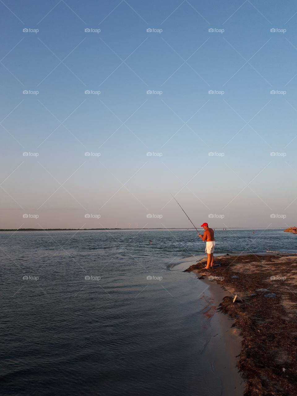 Fishermen at the sunset beach