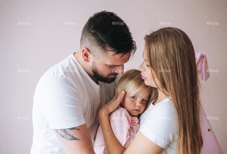 Happy multinational family father young man and mother with baby girl little daughter having fun in children room at home