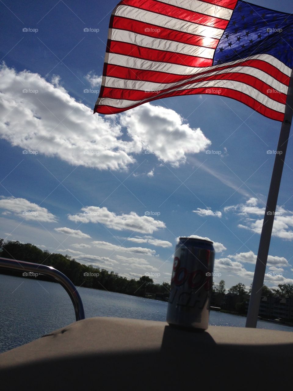 Old Glory. Summer fun on lake with drink and American flag
