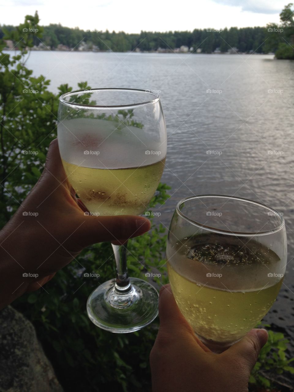 Drinking two glasses of cold white wine while looking at the lake. 