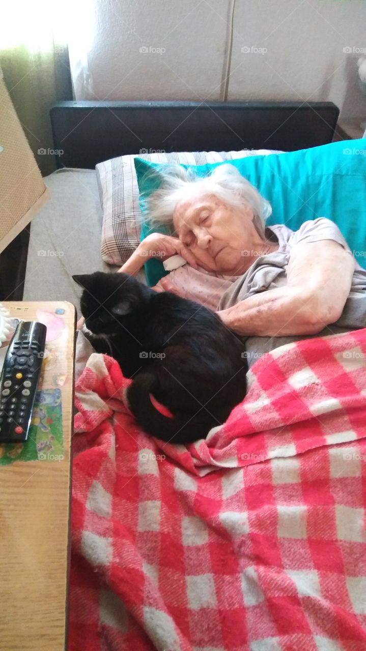my sweet 89 yr old momma (showing her how the cat sleeps at night)