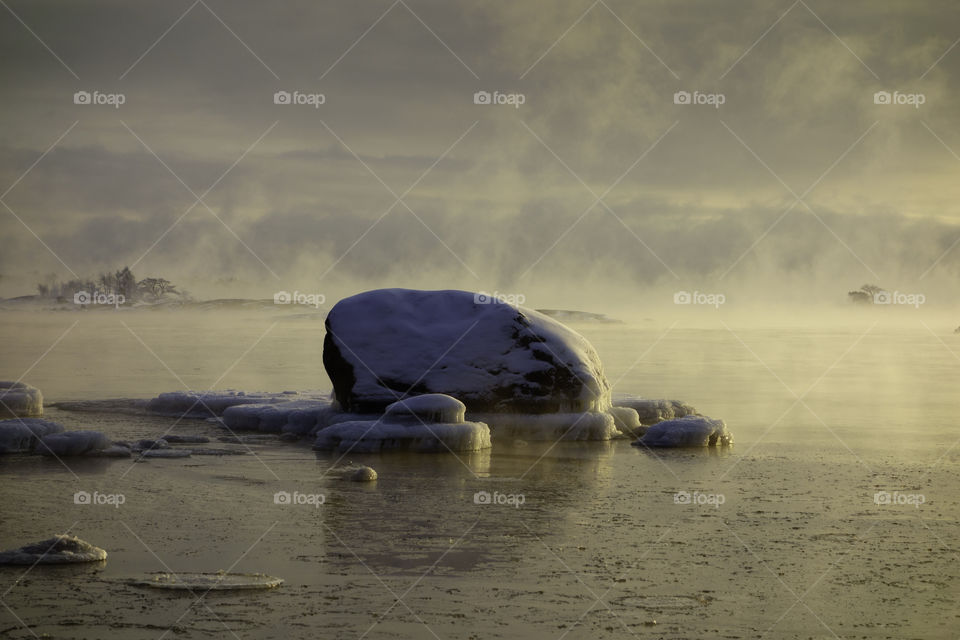 Ice covered rock in the Baltic Sea that about to freeze over in Helsinki, Finland on 6 January 2016