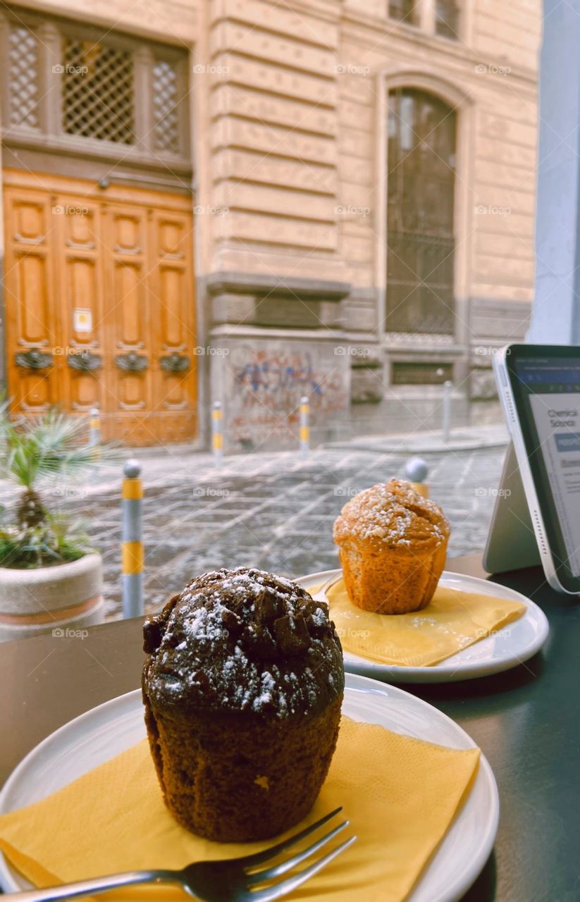 Pause your day for a moment of indulgence! 🍫☕ A chocolate dream paired with a golden classic muffin, enjoyed with a charming street view. Perfect for working, relaxing, or simply treating yourself. Taste the art of slow mornings!