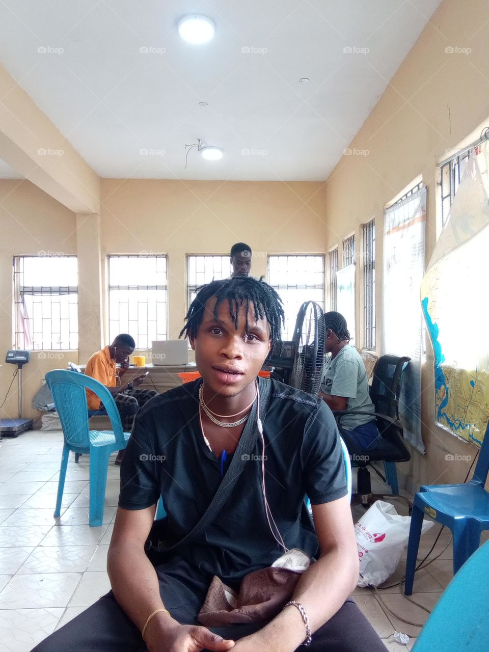 picture of a guy sitting an focusing on the camera