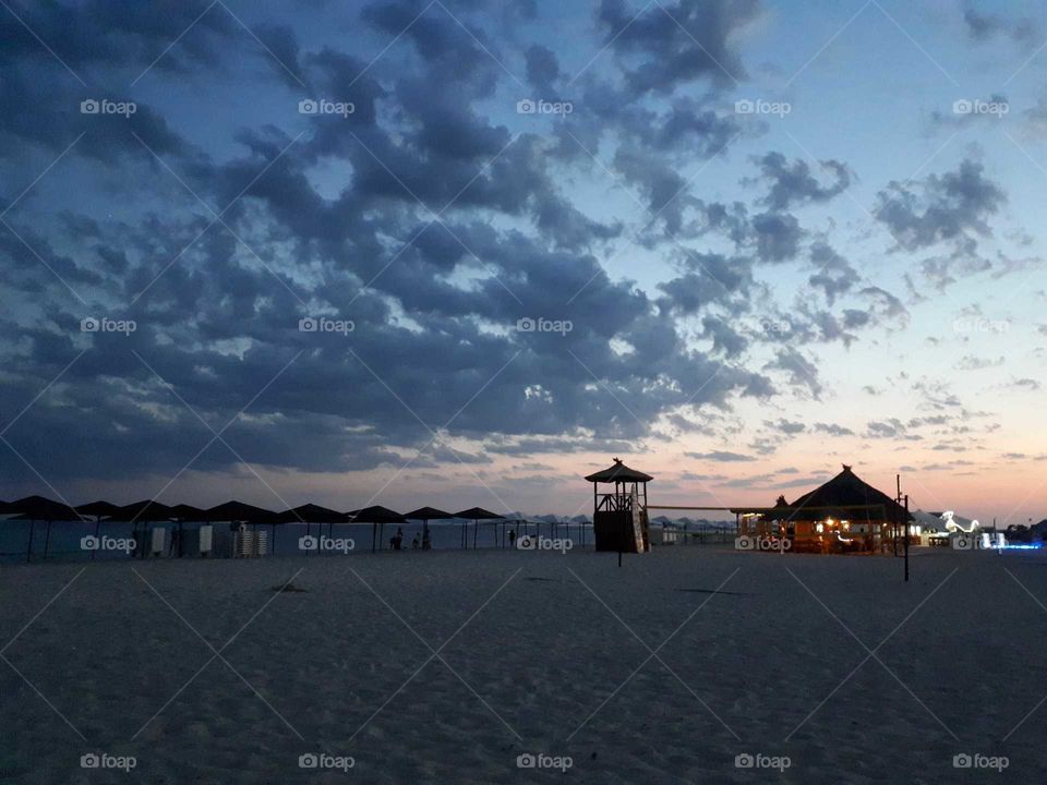 Evening at the sand beach with sunset