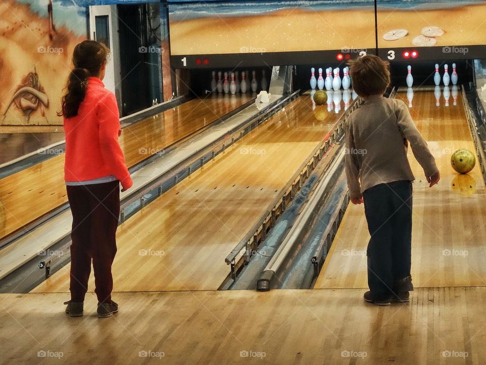 Children Playing At The Bowling Alley. American Bowling Alley