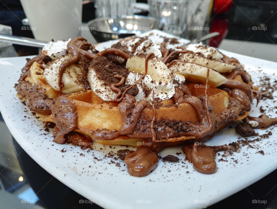 waffle with chocolate, banana, cookie and whipped cream