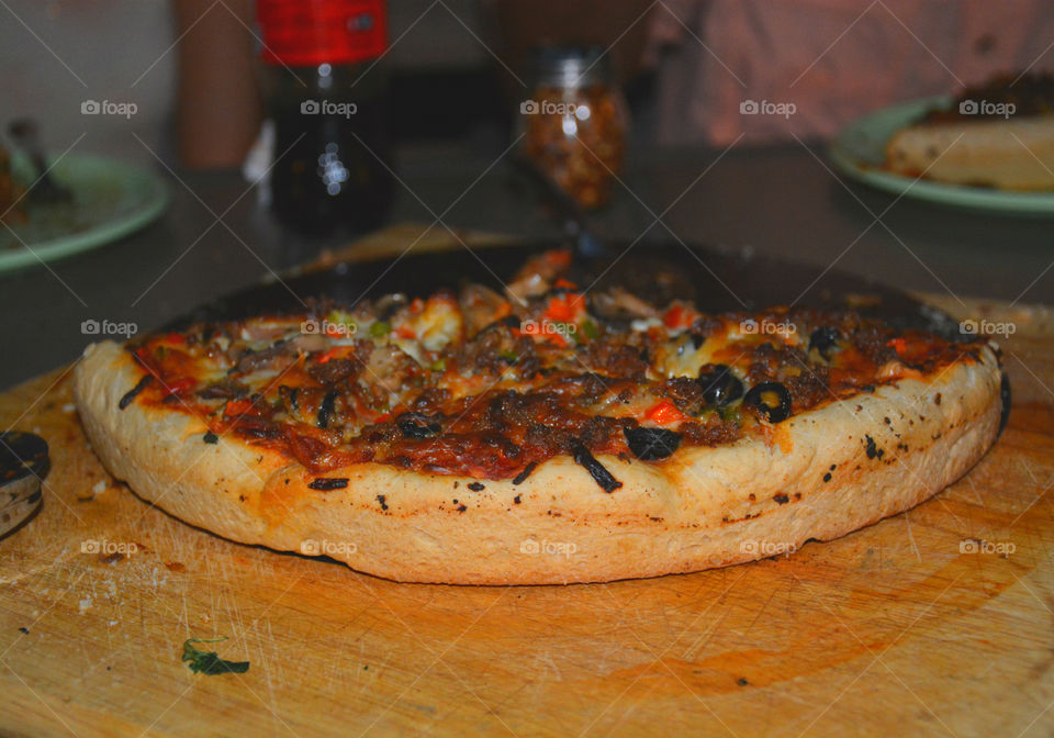 Delicious and nutritious homemade pizza with fresh, colorful vegetables, meats and a variety of spices! Grab a slice!