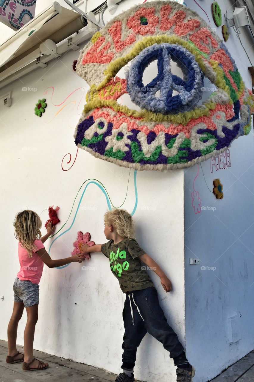 Children making art on wall