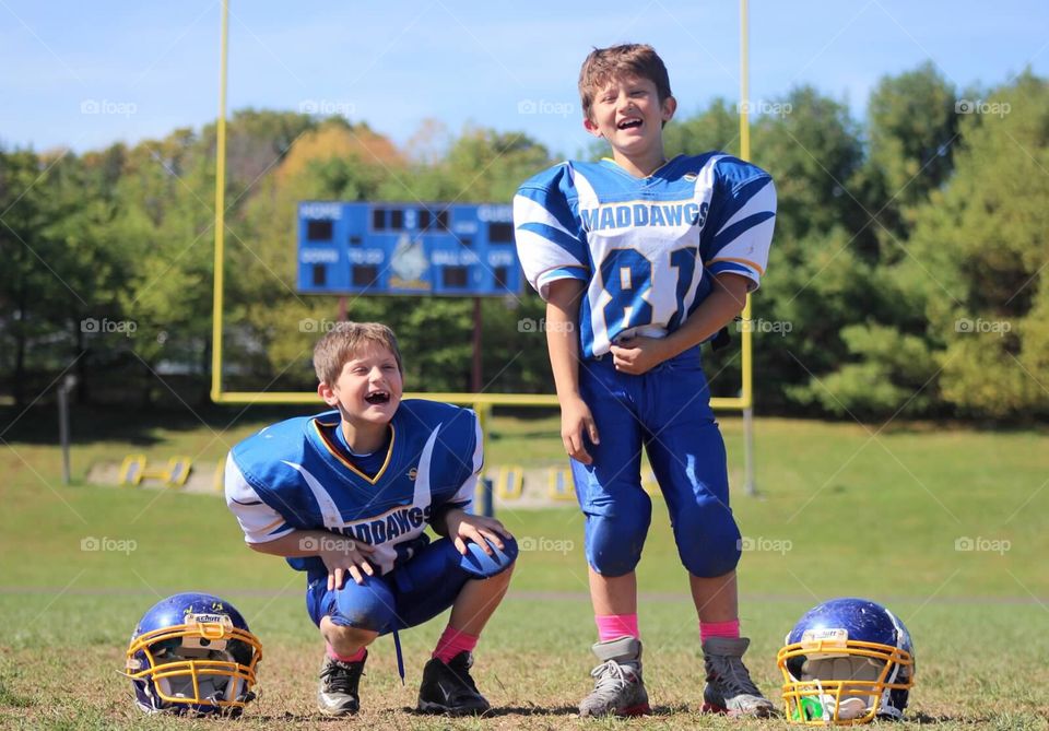 Two American football player laughing boy in the field