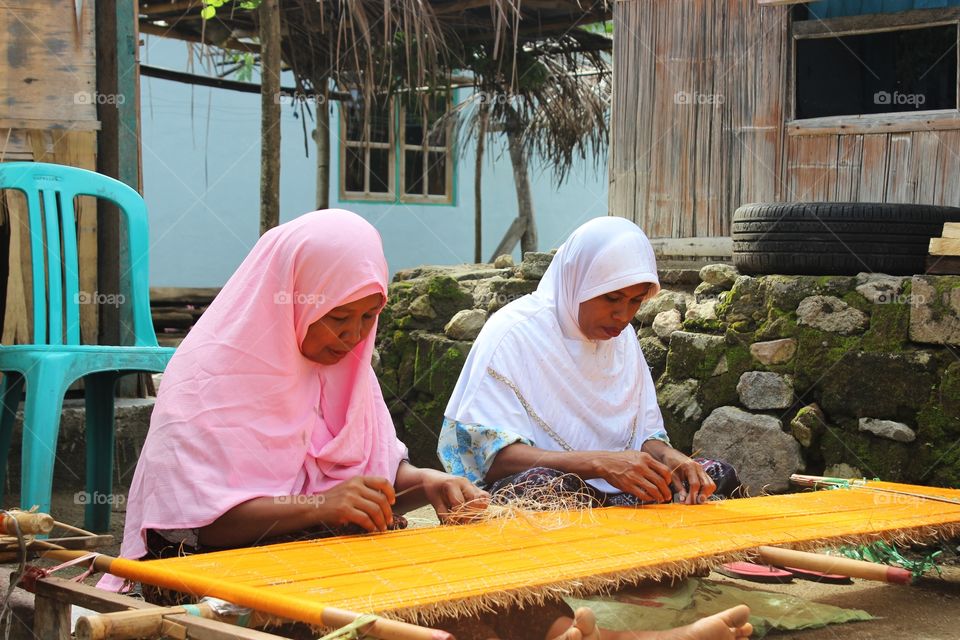 Weaver doing traditional ikat weave, Ende, Flores Island, Indonesia
