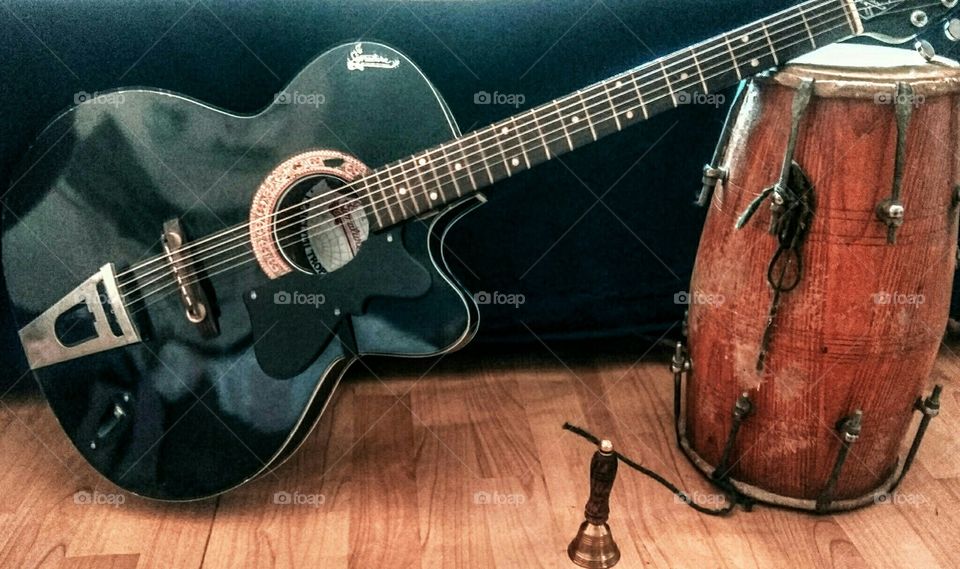 musical instruments guitar, tabla and bell( ganti used in regious purpose)