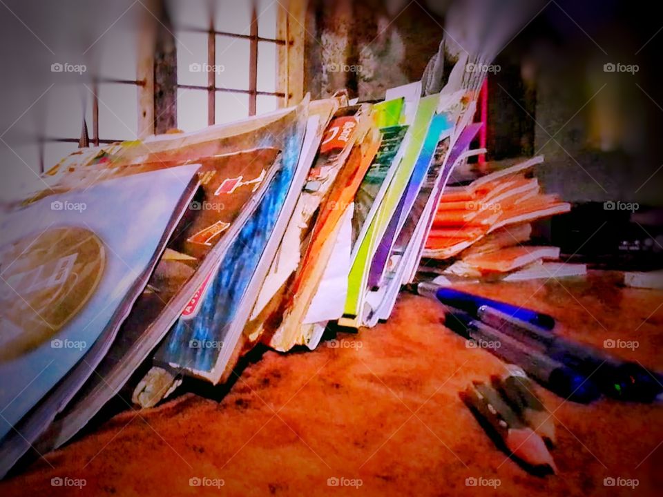 books,pen and pencil on the study table near the window