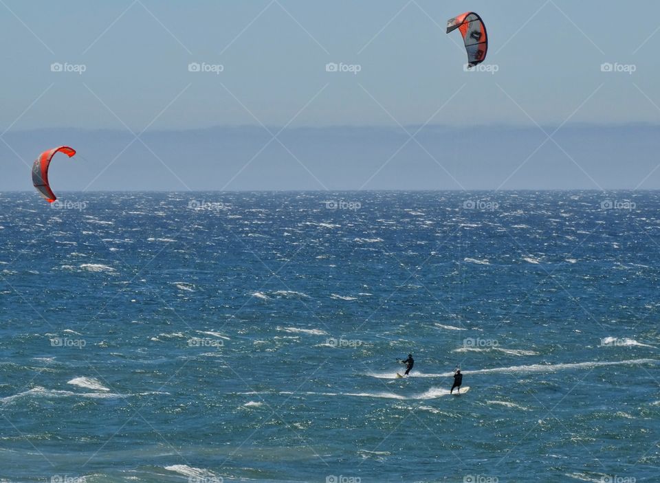 Windsurfing In The Ocean. Windsurfers Off 
The Coast Of California