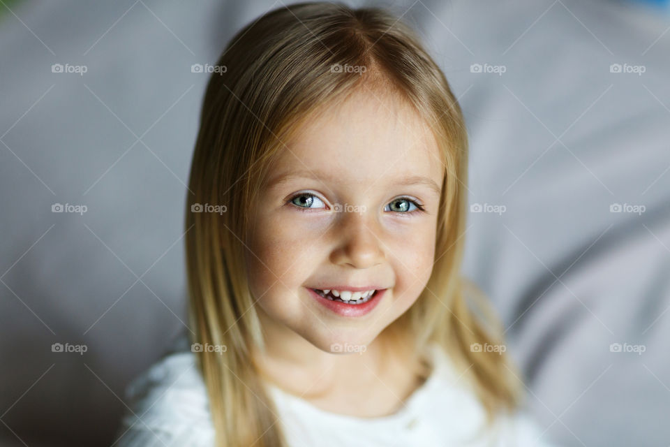 Portrait of cute little girl with blonde hair 