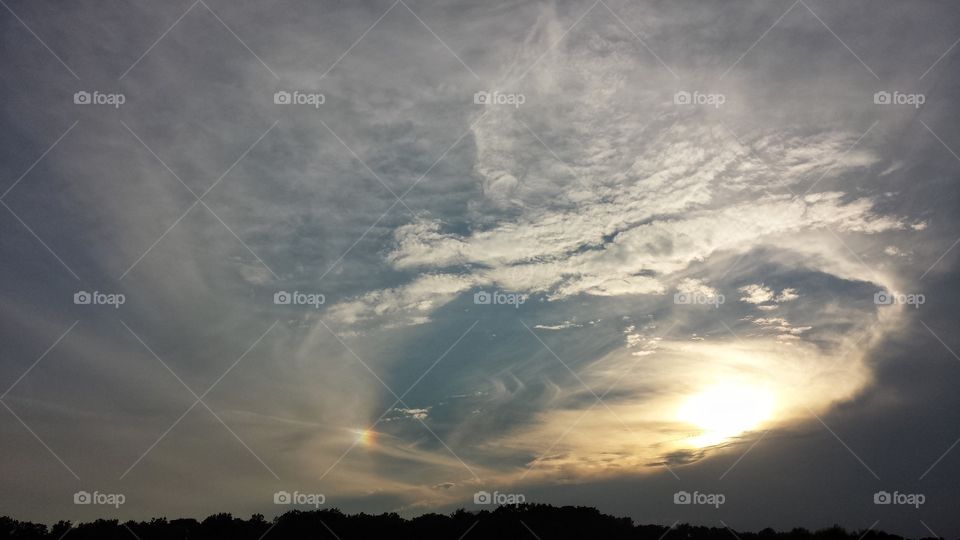 swirling clouds and sun-dog at sunset