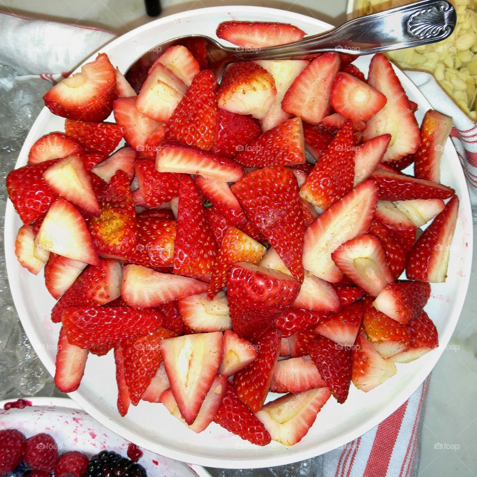 strawberries cut up in a bowl