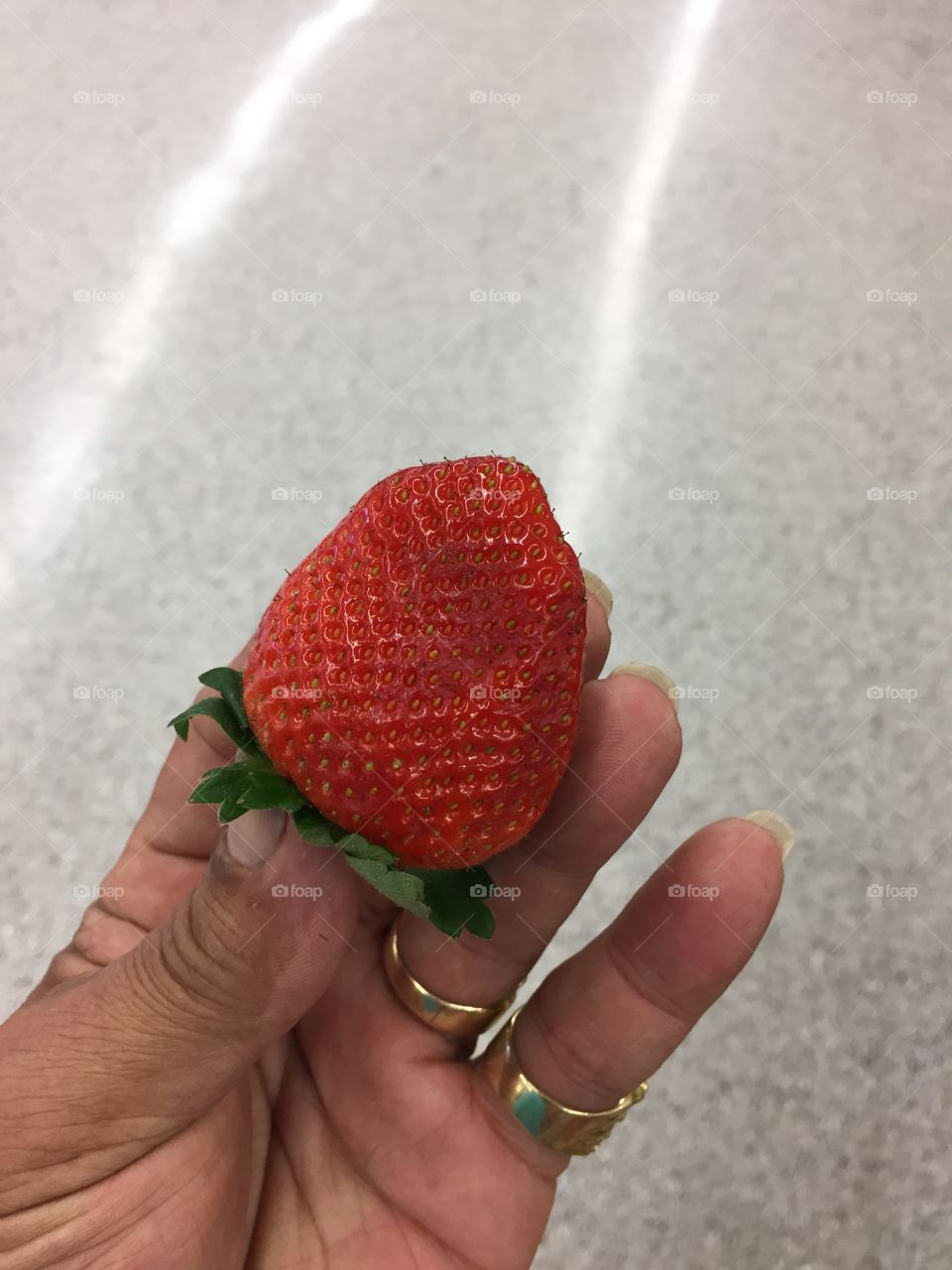 Woman's hand holding strawberry