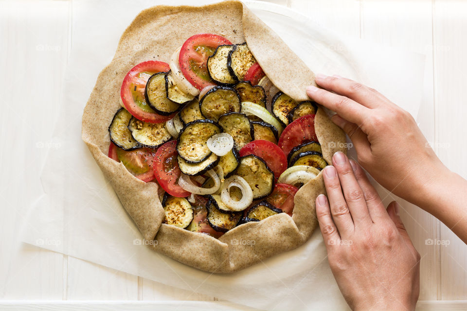 Cooking tartalet with eggplant, onion and tomatoes