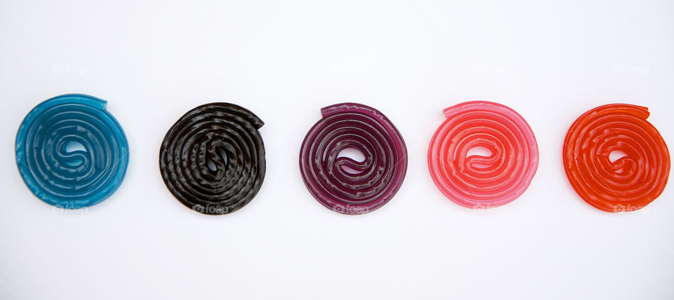 Colored liquorice spirals on a white background