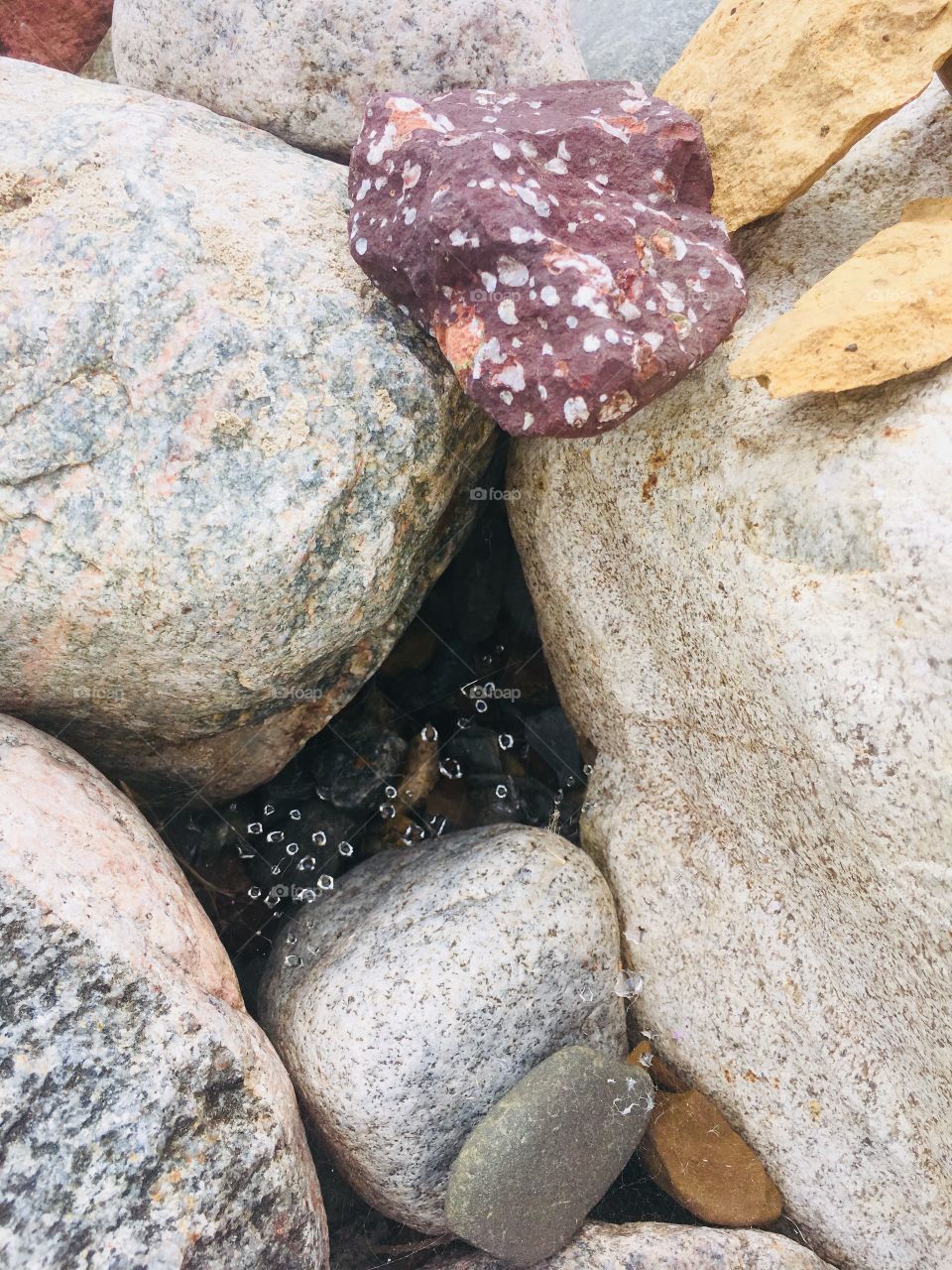 Rocks and water droplets on a spider web