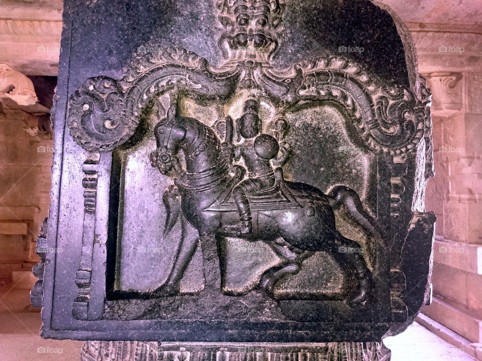 Soldier riding in horse towards a battlefield - Carved in stone in 15th century - Hampi